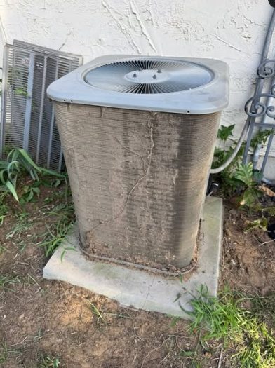 Condenser coil caked with dirt and debris before cleaning