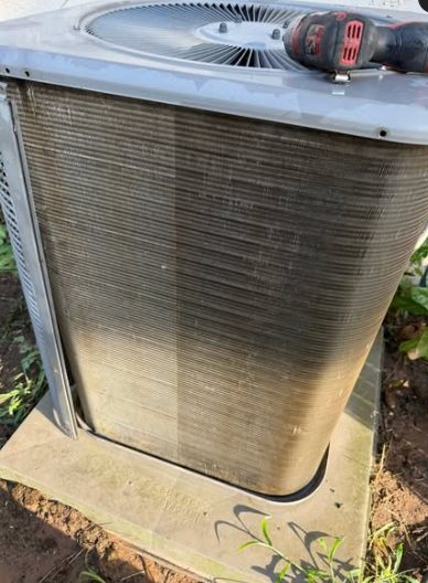The same condenser coil after washing, fins clear and metal visible